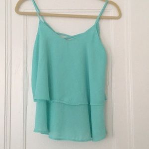 Francesca’s turquoise flowy tank